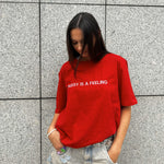 PUSSY IS A FEELING RED T-SHIRT WITH EMBROIDERED SIGN